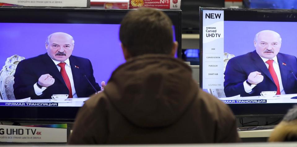 Belarus's President Alexander Lukashenko is seen on TV screens inside a shop, broadcast during a briefing in Minsk, Belarus, Friday, Feb. 3, 2017. In the televised broadcast on Friday, Lukashenko asked the country's interior minister to press charges against Russia's top food safety official, alleging charges of "damaging the state" because Russia stopped the import of Belarusian products due to quality issues and suspicions that Belarus resells EU-made dairy products that are banned in Russia. The Kremlin responded to the outburst, listing the loans and reduced taxes Russia gave to Belarus. (AP Photo/Sergei Grits)