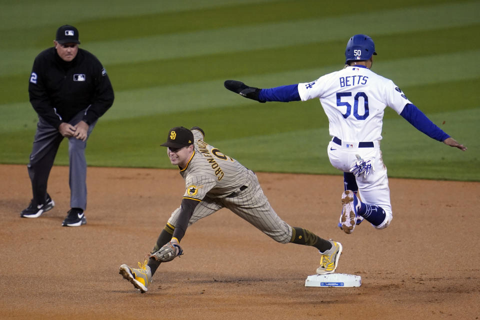 Los Angeles Dodgers' Mookie Betts (50) is forced out at second base by San Diego Padres second baseman Jake Cronenworth after a ground ball by Justin Turner during the first inning of a baseball game Thursday, April 22, 2021, in Los Angeles. (AP Photo/Marcio Jose Sanchez)