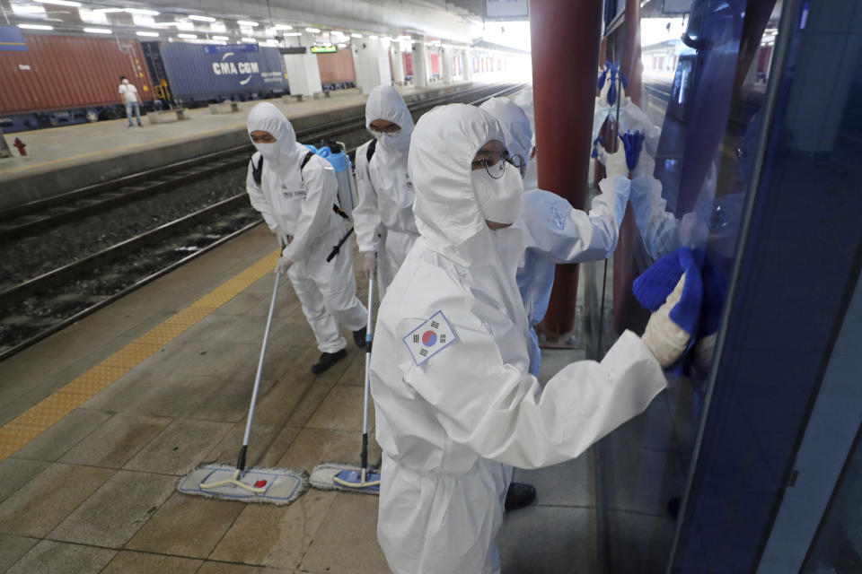 South Korean soldiers wearing protective gears disinfect as a precaution against the new coronavirus at a train station in Daejeon, South Korea, Thursday, June 25, 2020. (Kim Jun-beom/Yonhap via AP)