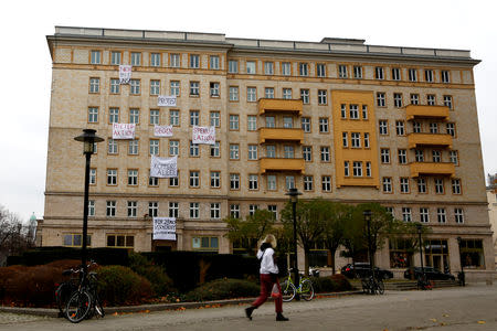 Banners hang from an apartment block on Karl Marx Allee in Berlin, Germany, November 20, 2018, to protest against plans to sell flats on a boulevard of imposing Stalinist architecture that was one of the flagship building projects of the former German Democratic Republic after World War Two. Banners read "Capitalist Avenue - flogged to Deutsche Wohnen for 28 Million". REUTERS/Joachim Herrmann