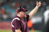 Virginia Tech interim head coach J.C. Price watches during the first half of an NCAA college football game against Miami, Saturday, Nov. 20, 2021, in Miami Gardens, Fla. (AP Photo/Lynne Sladky)