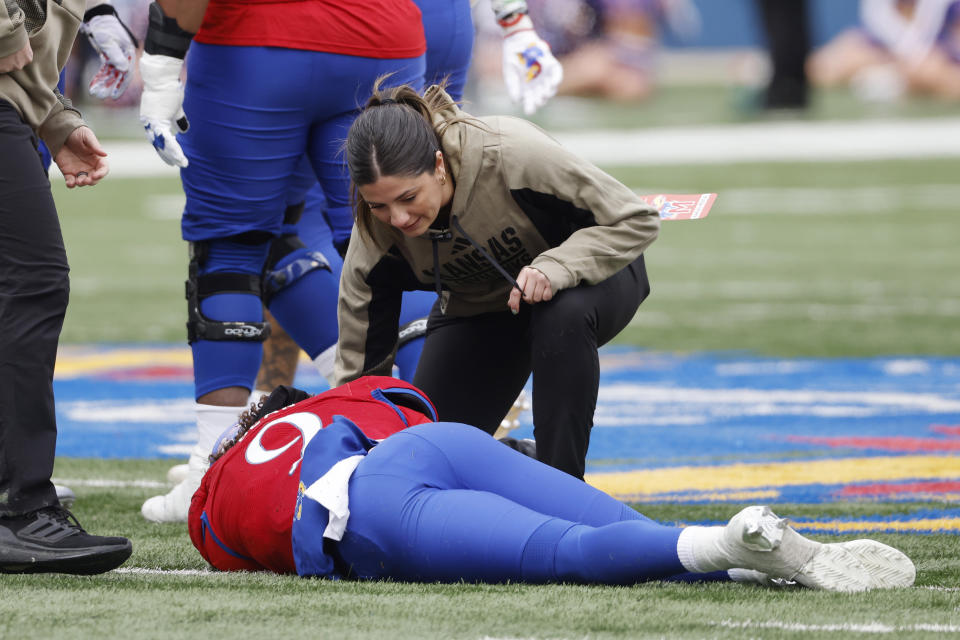 Kansas quarterback Jason Bean (9) lays injured as medical personnel assist during the first half of an NCAA college football game against Texas Tech, Saturday, Nov. 11, 2023, in Lawrence, Kan. (AP Photo/Colin E Braley)