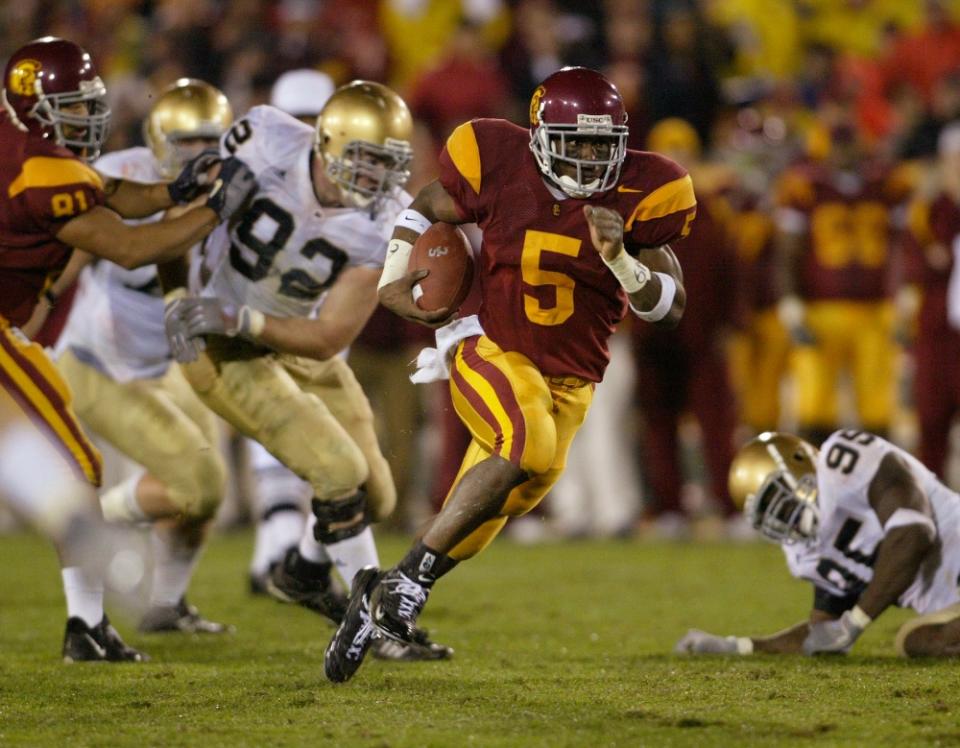 Nov 27, 2004; Los Angeles, CA, USA; Southern California Trojans tailback #5 Reggie Bush rushes during the second quarter of a 41-10 victory over the Notre Dame Fighting Irish at the Coliseum. Mandatory Credit: Photo by Jason Chan-USA TODAY Sports (©) Copyright 2004 by Jason Chan