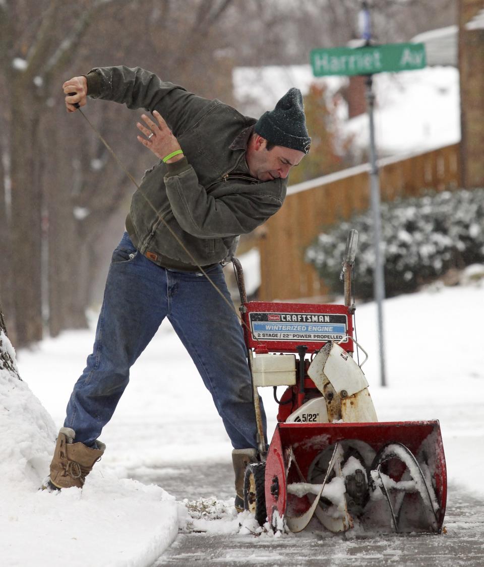 Ed Dozois starts his snowblower in Minneapolis, November 10, 2014. An arctic blast began to dump heavy snow in parts of the northern Rockies, Plains and the Great Lakes regions on Monday and meteorologists said temperatures are expected to plummet throughout the United States. (REUTERS/Eric Miller)