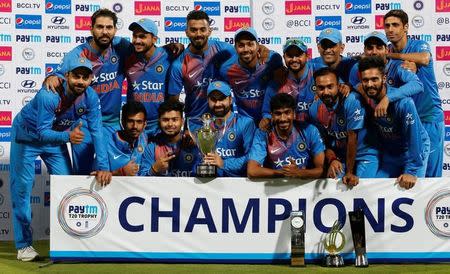 Cricket - India v England - Third T20 International - M Chinnaswamy Stadium, Bengaluru, India - 01/02/17. India's players pose with the trophy after winning the series. REUTERS/Danish Siddiqui