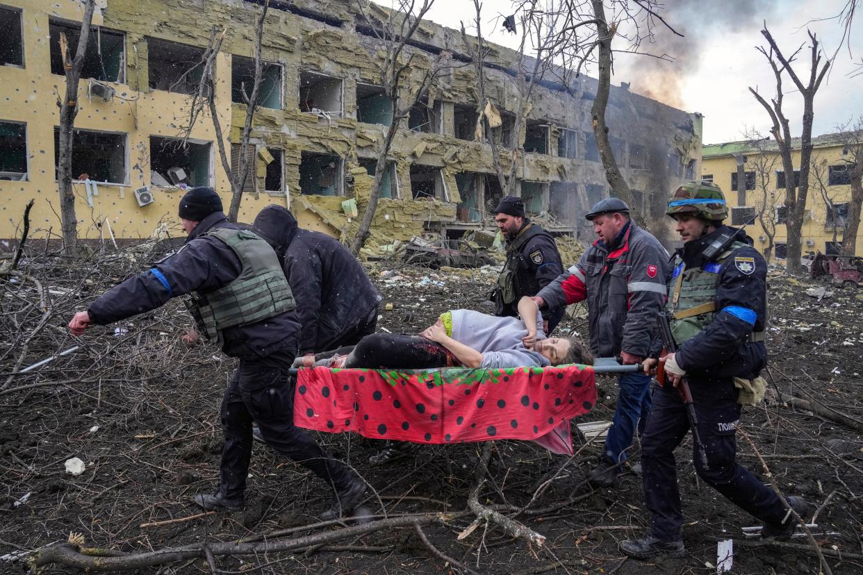 Iryna Kalinina, 32, an injured pregnant woman, is carried from a maternity hospital that was damaged during a Russian airstrike in Mariupol, Ukraine on 9 March 2022 (AP)