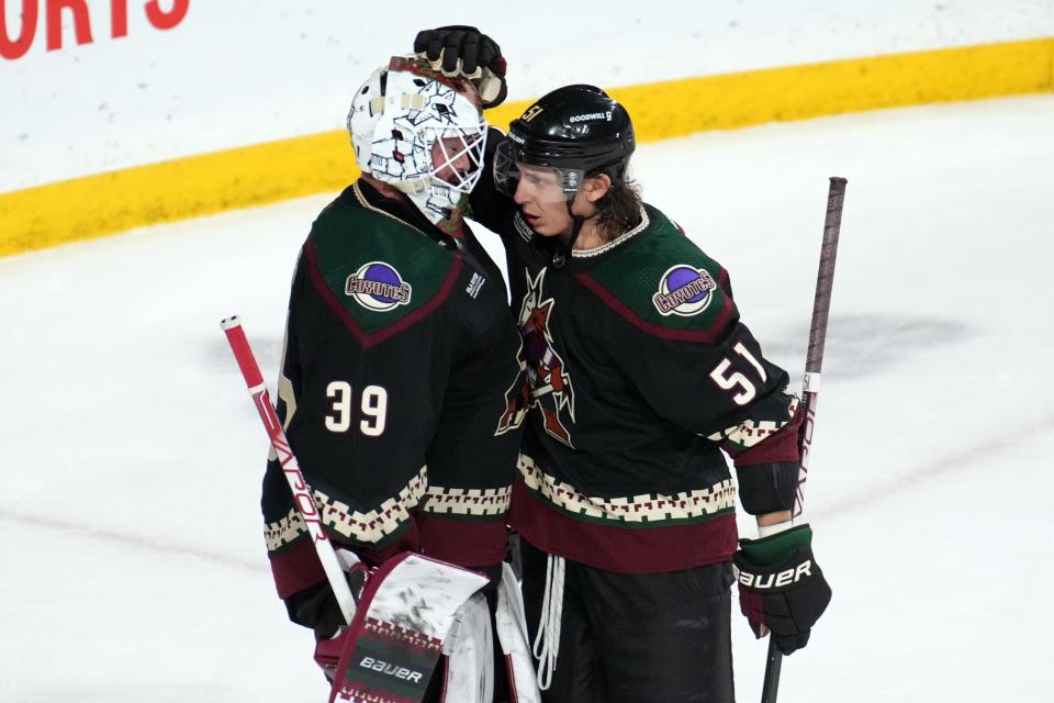 Arizona Coyotes goaltender Connor Ingram (39) and Arizona Coyotes defenseman Troy Stecher (51) celebrate after defeating the Colorado Avalanche at Mullett Arena in Tempe on Dec. 27, 2022.