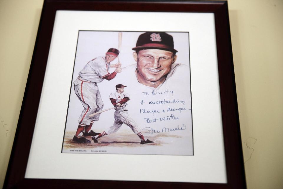 In this March 13, 2014 photo, a framed and signed picture from Stan Musial hangs on a wall at Dusty Baker's home in Granite Bay, Calif. Out of uniform for the first time since taking 2007 off between managerial jobs with the Cubs and Reds, Baker is not slowing down much from his pressure-packed days in the dugout. (AP Photo/Eric Risberg)