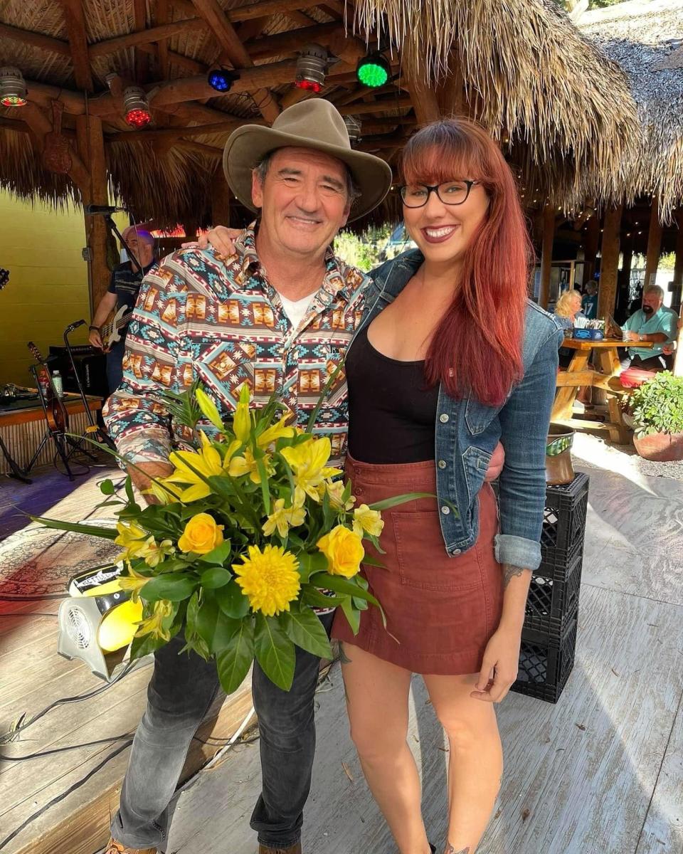 Greg Poulos stands next to his daughter Sarah Bikos at a 70th birthday celebration for him at Stottlemyer's Smokehouse. The Sarasota venue will hold a public celebration of life for Poulos starting at noon Sunday, with live music.