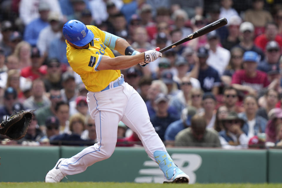 Boston Red Sox's Adam Duvall hits an RBI single in the fifth inning of the first game of a baseball doubleheader against the New York Yankees, Sunday, June 18, 2023, in Boston. (AP Photo/Steven Senne)