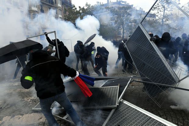 16 H 28, PLACE D’ITALIE Les black blocs se servent de panneaux de chantier pour construire une barricade. Ils seront chassés par des gaz lacrymogènes