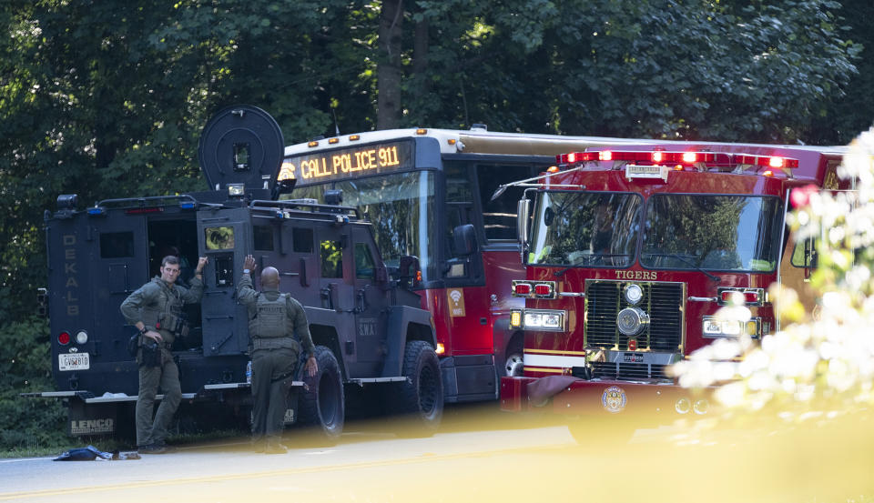 A Gwinnett County, Ga. commuter bus sits in the road where it was stopped in Smoke Rise, Ga., on Tuesday, June 11, 2024. Atlanta police say the transit bus fled from officers responding to a dispute on board, leading them on a wild and lengthty chase into a neighboring county before it was stopped. (AP Photo/Ben Gray)