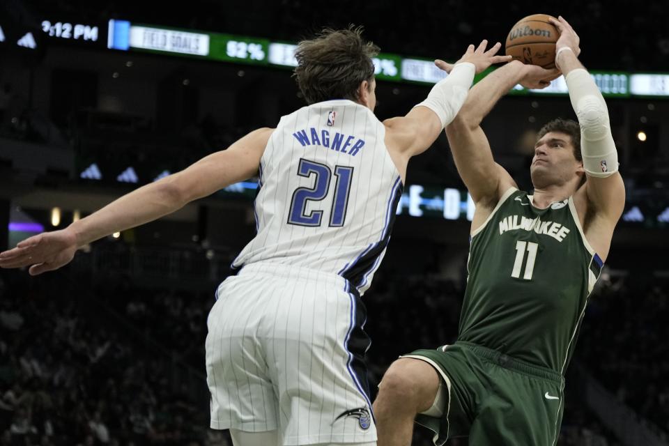 Milwaukee Bucks' Brook Lopez shoots past Orlando Magic's Moritz Wagner during the second half of an NBA basketball game Wednesday, April 10, 2024, in Milwaukee. (AP Photo/Morry Gash)