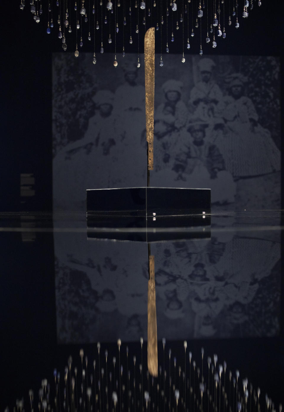 A machete used for cutting sugar cane is displayed at the Slavery exhibition Rijksmuseum in Amsterdam, Netherlands, Monday, May 17, 2021. The stark contrast between finery and brutality, wealth and inhumanity is a recurring pattern at the museum's unflinching new exhibition titled, simply, "Slavery", that examines the history of Dutch involvement in the international slave trade. (AP Photo/Peter Dejong)