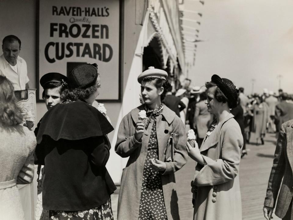 Women enjoying frozen custard on the Coney Island boardwalk in 1900.