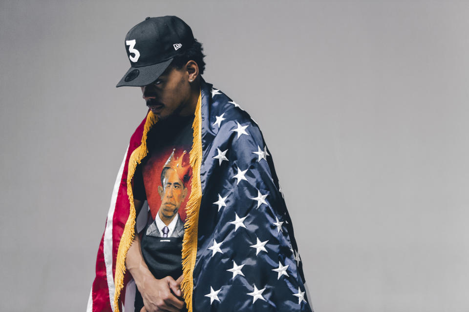 This undated image released by Nolis Anderson shows Chance the rapper draped in an American flag and wearing Obama-themed clothing made by Joe Fresh Goods' "Thank You Obama" line. (Nolis Anderson via AP)