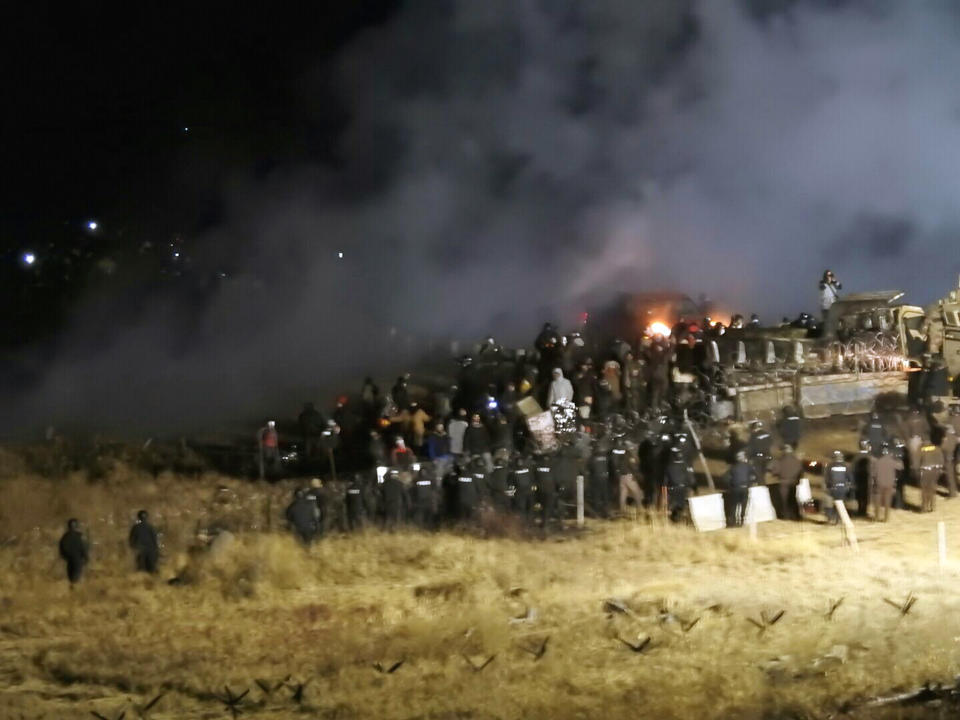 FILE - In this Nov. 20, 2016 file photo, provided by Morton County Sheriff's Department, law enforcement and protesters clash near the site of the Dakota Access pipeline in Cannon Ball, N.D. A western South Dakota sheriff is seeking to be dismissed from a lawsuit challenging new state laws that aim to prevent disruptive demonstrations against the Keystone XL oil pipeline similar to those a few years ago in North Dakota against the Dakota Access pipeline. Attorneys for Pennington County Sheriff Kevin Thom say he must enforce state laws but isn't responsible for defending them. They also argue the lawsuit is baseless. The American Civil Liberties Union and American Indian tribes maintain the legislation stifles free speech. (Morton County Sheriff's Department via AP, File)