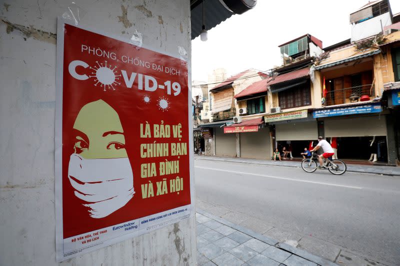 A poster warning about the coronavirus disease (COVID-19) is seen on a street in Hanoi