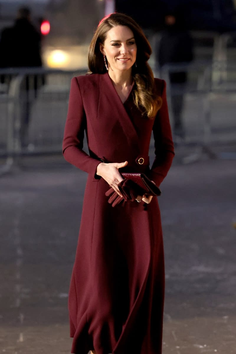 <p> Opting for another, fully monochromatic look, Kate embraced the festive maroon hue for the 'Together at Christmas' Carol Service, wearing a coat dress, matching gloves and heels, accessorised with a crocodile-style clutch bag in a deep burgundy hue. </p>