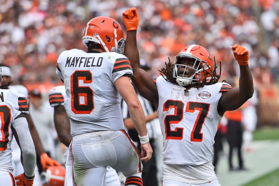 Cleveland Browns quarterback Baker Mayfield (6) celebrates with running back Kareem Hunt (27) after Hunt scored a 29-yard touchdown during the second half of an NFL football game against the Chicago Bears, Sunday, Sept. 26, 2021, in Cleveland. (AP Photo/David Richard)