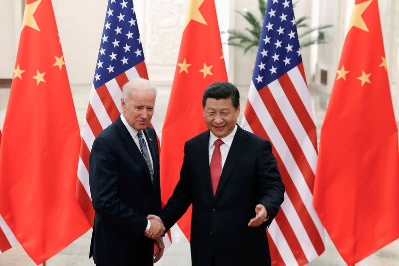 FILE PHOTO: Chinese President Xi Jinping shakes hands with U.S. Vice President Joe Biden inside the Great Hall of the People in Beijing