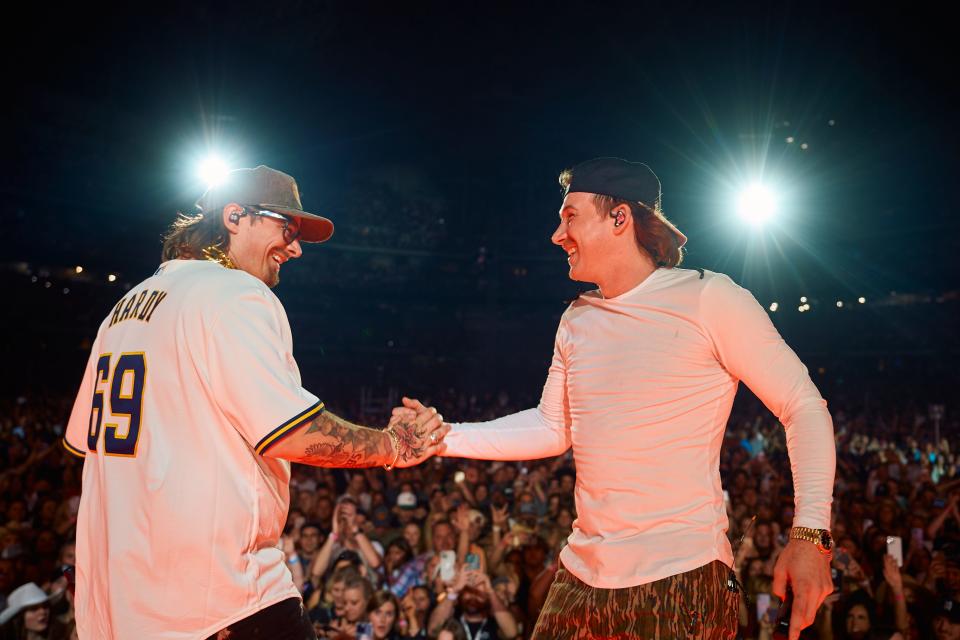 Hardy, left, and Morgan Wallen share a moment onstage at American Family Field in Milwaukee on Friday, April 14, 2023, the first show of Wallen's two-night stand at the Milwaukee stadium kicking off his North American tour.