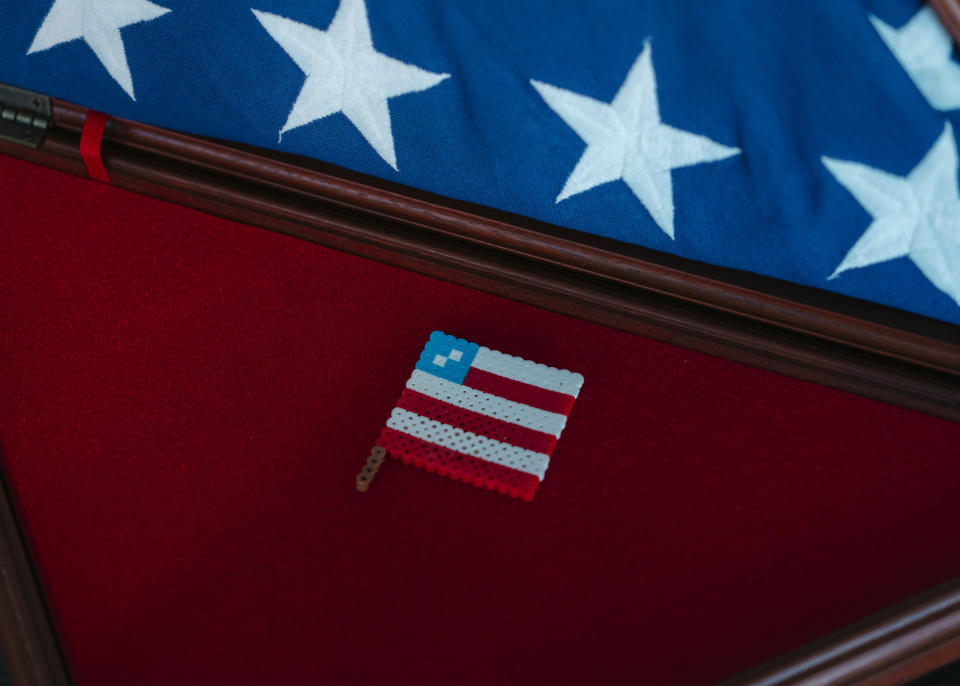 A flag figurine made by Marine 1st Lt. Matthew Davis step-daughter Aubrey Jones placed near his burial flag.  (Photo: Justin T. Gellerson for HuffPost)