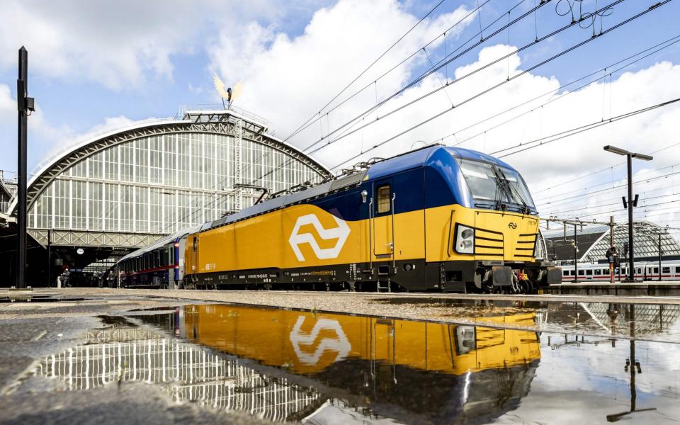 yellow train pulling out of station  - REMKO DE WAAL /AFP 