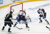 Seattle Kraken right wing Jordan Eberle (7) looks to shoot and would score around Colorado Avalanche center Evan Rodrigues (9) and goaltender Alexandar Georgiev, back center, to win the game during overtime in Game 4 of an NHL hockey Stanley Cup first-round playoff series Monday, April 24, 2023, in Seattle. The Kraken won 3-2 in overtime. (AP Photo/Lindsey Wasson)