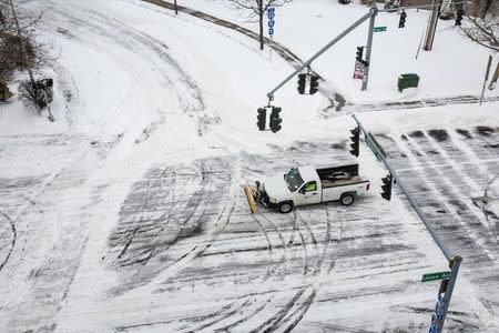 A snow plow makes it way through town in New Haven, Connecticut January 27, 2015. REUTERS/Michelle McLoughlin