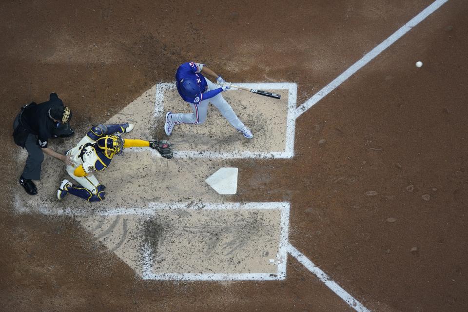 Texas Rangers' Marcus Semien hits an RBI single during the fifth inning of a baseball game against the Milwaukee Brewers Monday, June 24, 2024, in Milwaukee. (AP Photo/Morry Gash)