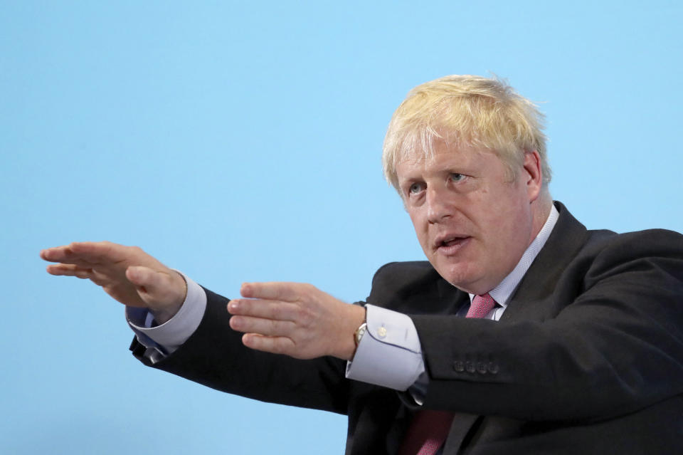 Conservative Party leadership candidate Boris Johnson gestures, during a Conservative leadership hustings in Maidstone, England, Thursday July 11, 2019. (Gareth Fuller/PA via AP)