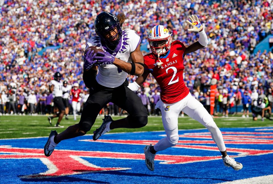 TCU wide receiver Quentin Johnston (1) catches a touchdown pass against Kansas cornerback Cobee Bryant (2) during the second half at David Booth Kansas Memorial Stadium.