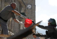 <p>Rescuers frame the clock on the Torre Civica in Amatrice Italy, Wednesday, Aug. 24, 2016, that is stuck at 3:36 a.m. following an earthquake. (AP Photo/Alessandra Tarantino) </p>