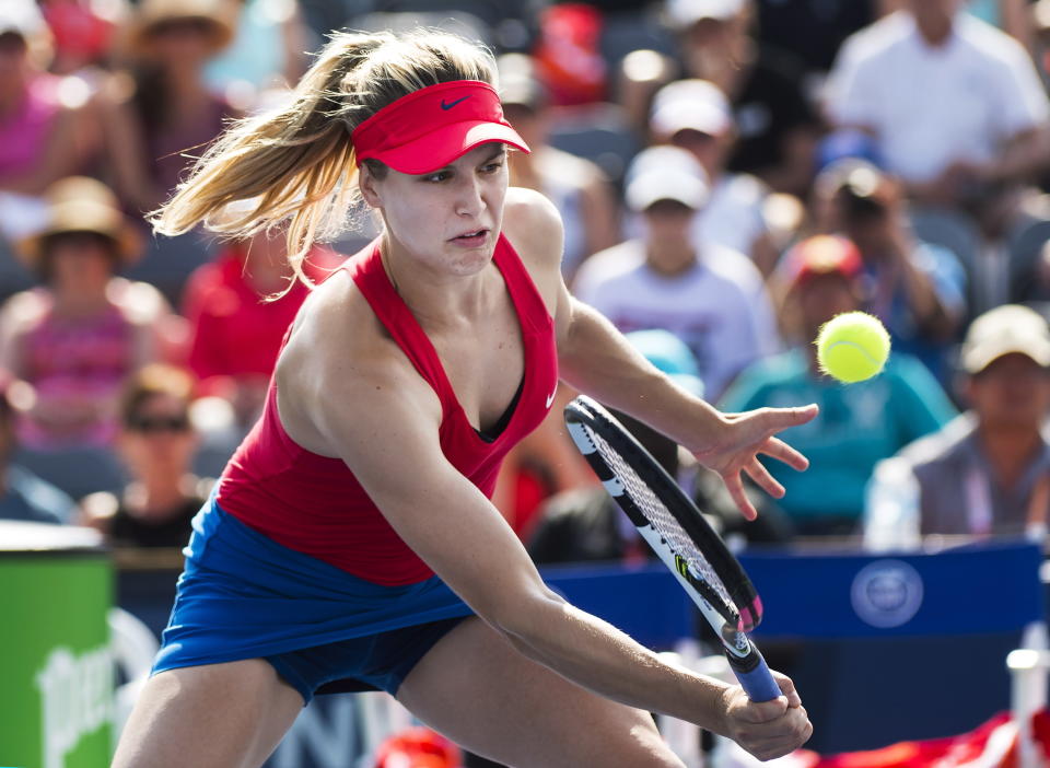 Eugenie Bouchard, of Canada, returns the ball while playing doubles with partner Karolina Pliskova, of the Czech Republic, against Anna-Lena Groenefeld, of Germany, and Kveta Peschke, of the Czech Republic, at the Rogers Cup tennis tournament in Toronto on Thursday, Aug. 10, 2017. (Nathan Denette/The Canadian Press via AP)