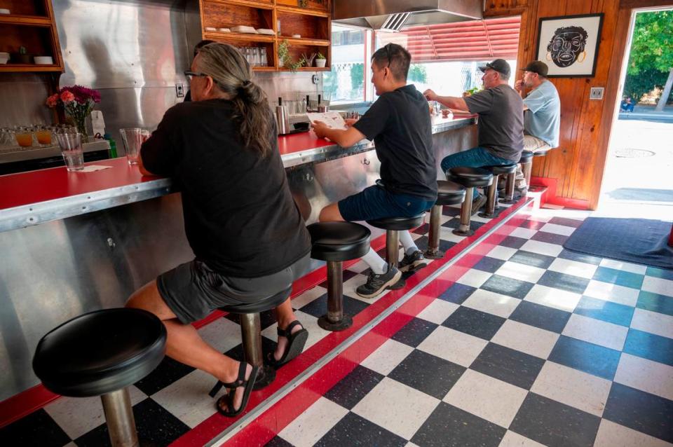 Patrons sit inside the Sacramento landmark Jim-Denny’s in September.