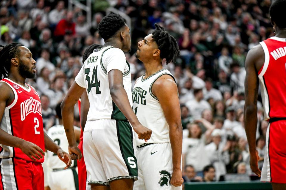 Michigan State's Xavier Booker, left, celebrates his dunk with A.J. Hoggard, right, during the second half in the game against Ohio State on Sunday, Feb. 25, 2024, at the Breslin Center in East Lansing.