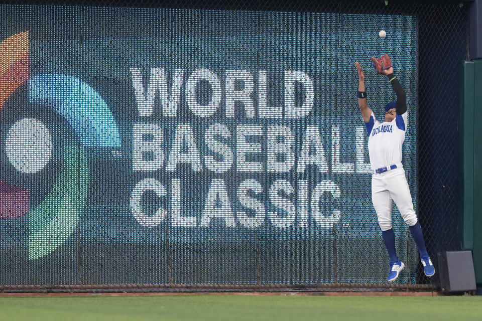 Nicaragua center fielder Juan Diego Montes (99) catches a hit deep into center field by Dominican Republic's Manny Machado during the first inning of a World Baseball Classic game, Monday, March 13, 2023, in Miami. (AP Photo/Marta Lavandier)