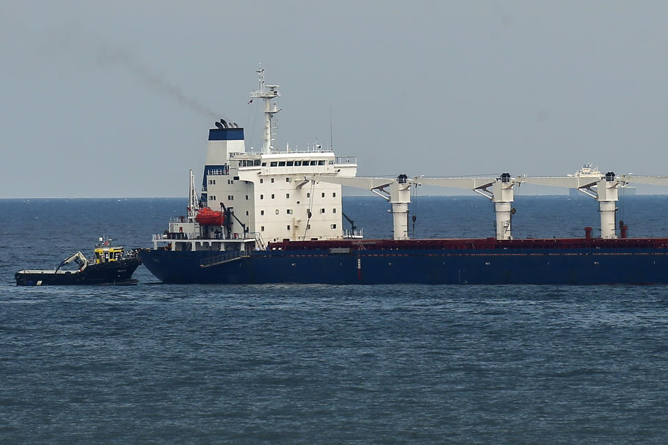 A boat with Russian, Ukrainian, Turkish and U.N. officials heads to the Sierra Leone-flagged cargo ship Razoni, to check if the grain shipment is in accordance with a crucial agreement signed last month by Moscow and Kyiv, at an inspection area in the Black Sea off the coast of Istanbul, Turkey, Wednesday, Aug. 3, 2022. The cargo ship Razoni, loaded up with 26,000 tons of corn, set sail from Ukraine's Odesa on Monday, enroute to final destination, Lebanon.(AP Photo/Emrah Gurel)