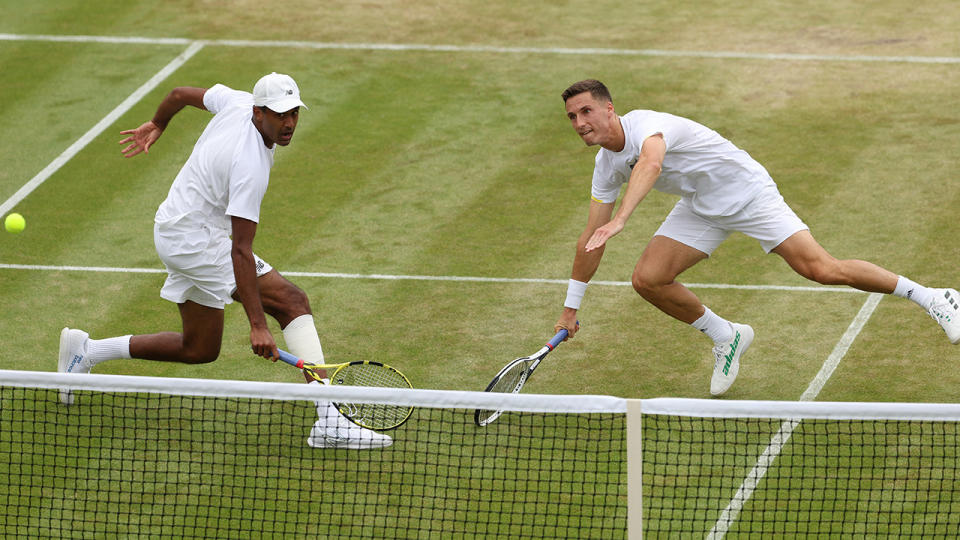 Rajeev Ram and Joe Salisbury are pictured playing in the quarter final of the Wimbledon men's doubles.