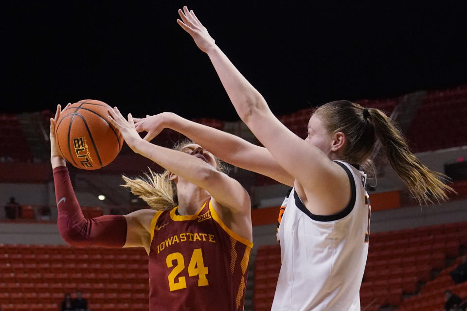 Iowa State guard Ashley Joens (24) is defended by Oklahoma State forward Lior Garzon, right, in the first half of an NCAA college basketball game Wednesday, Feb. 22, 2023, in Stillwater, Okla. (AP Photo/Sue Ogrocki)