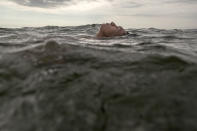 <p>A man floats in the Pacific Ocean off Agua Dulce beach in Lima, Peru, Thursday, Feb. 23, 2017. Residents living in the capital city cool off on hot summer days by going to the nearby beaches. (Photo: Rodrigo Abd/AP) </p>