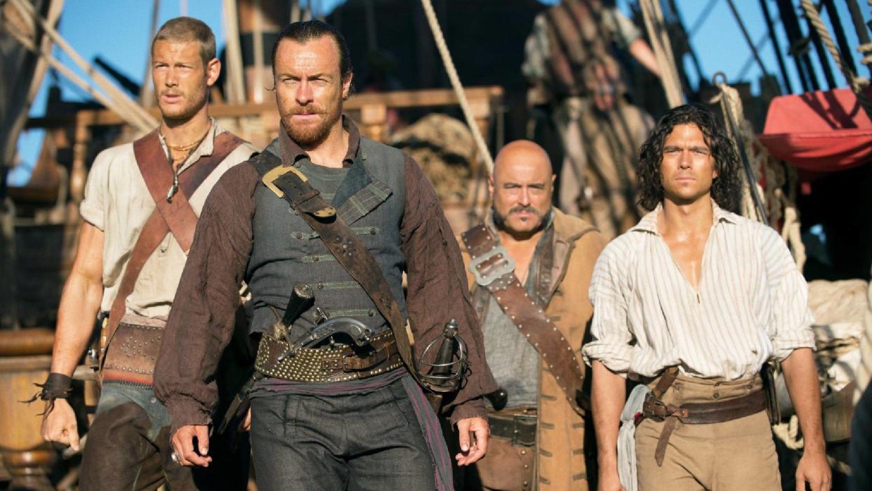  (L-R) Tom Hopper as William Manderly, Toby Stephens as Captain Flint, Mark Ryan as Hal Gates and Luke Arnold as Long John Silver in Black Sails now streaming Netflix. 