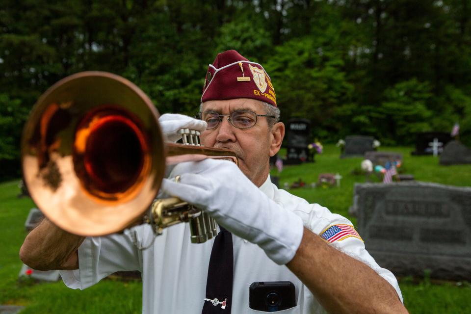 Jerry Primmer, of Sugar Grove, is the trumpet player for the Lancaster Veteran Burial Detail stands in the cemetery with his trumpet at Trinity Lutheran Church (Sponagle) in Sugar Grove, Ohio on May 20, 2022. Primmer was a firefighter for the Lancaster Fire Department for 33 years. He also served in the Army Reserves from 1966 to 1972.