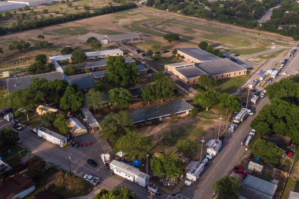 This aerial view, shows Robb Elementary School and the makeshift memorial (C, Bottom) for the shooting victims in Uvalde, Texas, on May 28, 2022