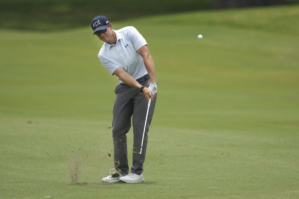 Adam Schenk hits an approach shot on the second hole during the final round of the Charles Schwab Challenge golf tournament at Colonial Country Club in Fort Worth, Texas, Sunday, May 28, 2023. (AP Photo/LM Otero)