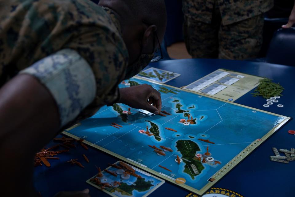 US Marine Corps officers assigned to the 22nd Marine Expeditionary Unit (MEU) conduct a wargaming scenario aboard Amphibious Assault Ship USS Kearsarge (LHD 3), Oct. 22, 2021