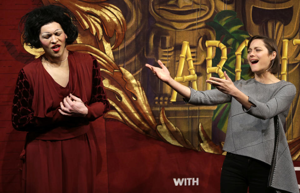 Actress Marion Cotillard, of France, right, sings Je Ne Regrette Rien, as Harvard University theatrical student Ethan Hardy, left, plays the role of Edith Piaf, in a spoof during Hasty Pudding Theatricals award ceremonies, at Harvard University, in Cambridge, Mass., Thursday, Jan. 31, 2013. Cotillard was awarded Hasty Pudding Theatricals woman of the year by the student theatricals society at Harvard. Cotillard played the staring role in a film about Piaf. (AP Photo/Steven Senne)