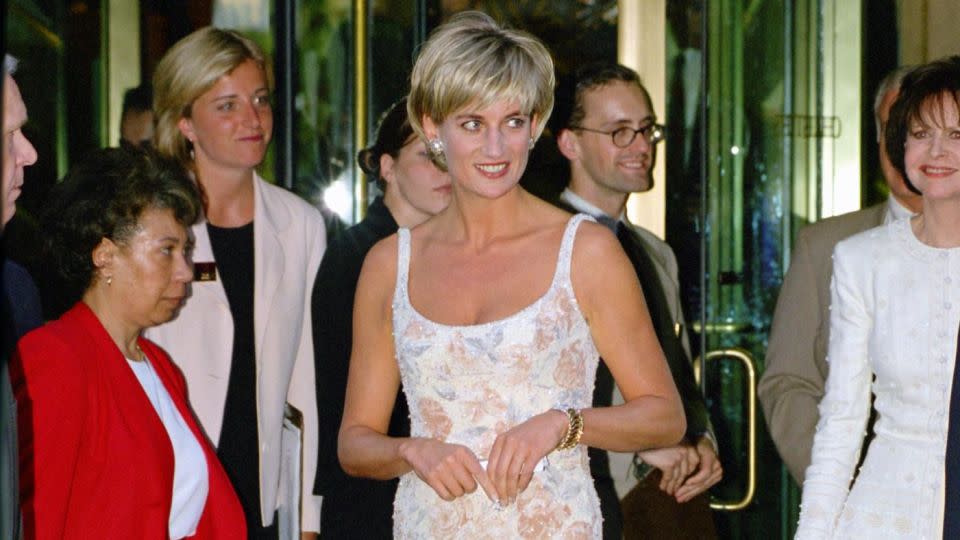 Princess Diana wearing a Catherine Walker mini dress to the launch of a 1997 Christie's auction, where she sold many of her most iconic outfits. - Tim Graham Photo Library/Getty Images