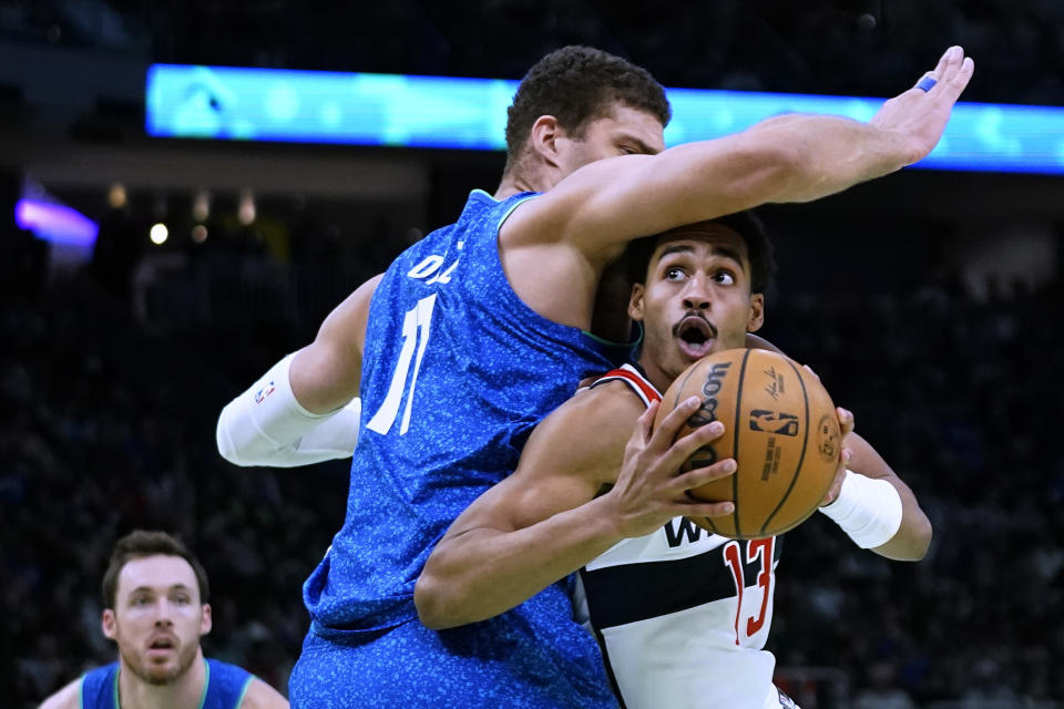 Washington Wizards' Jordan Poole drives to the basket against Milwaukee Bucks' Brook Lopez during the second half of an NBA basketball In-Season Tournament game Friday, Nov. 24, 2023, in Milwaukee. (AP Photo/Aaron Gash)